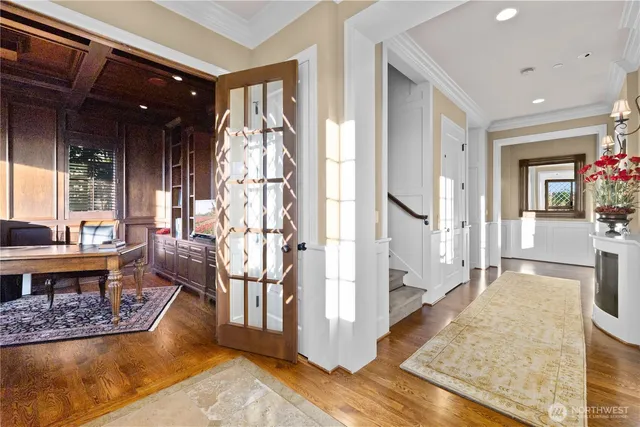 a living room with fireplace furniture and a rug