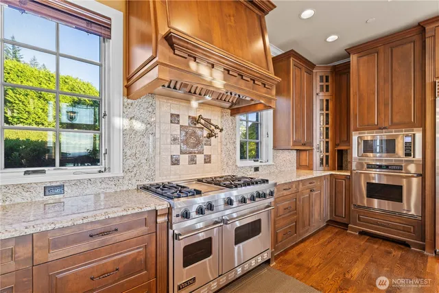 a kitchen with stainless steel appliances granite countertop a stove and a sink