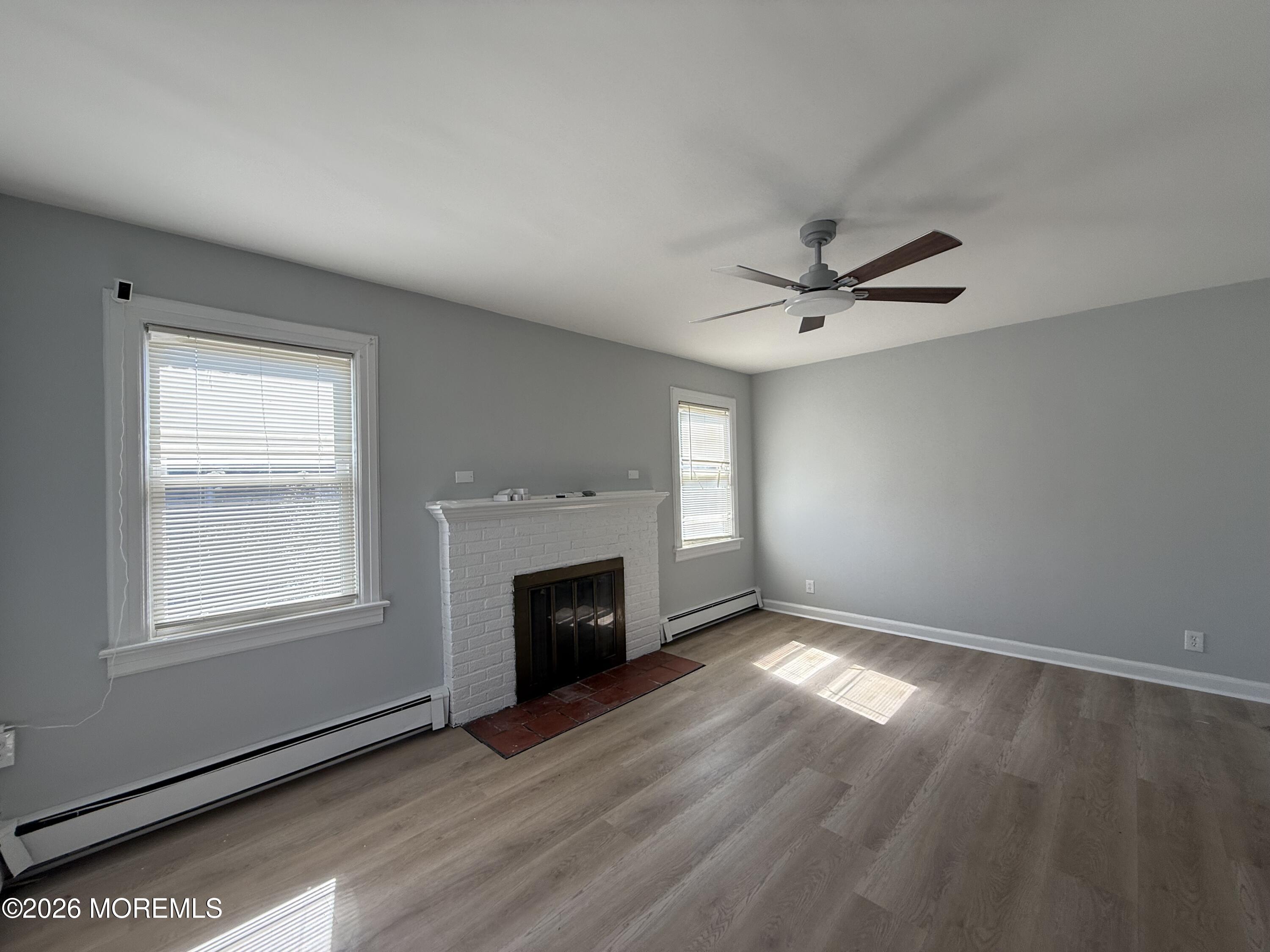 464 2nd Avenue, Unit 1 Long Branch, NJ 07740 - Photo 13 of 37 an empty room with windows and fireplace