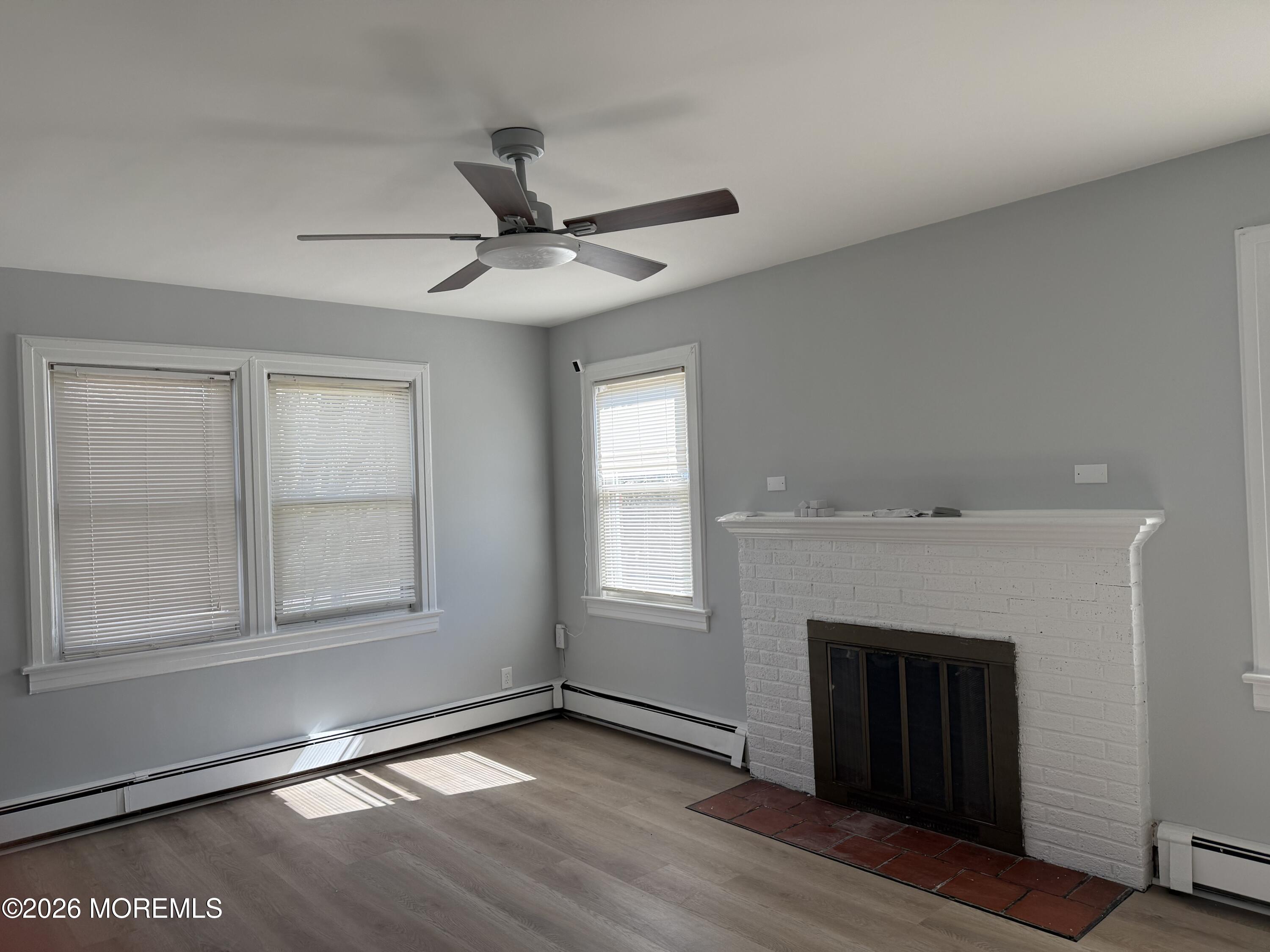 464 2nd Avenue, Unit 1 Long Branch, NJ 07740 - Photo 15 of 37 a view of an empty room with wooden floor and a window