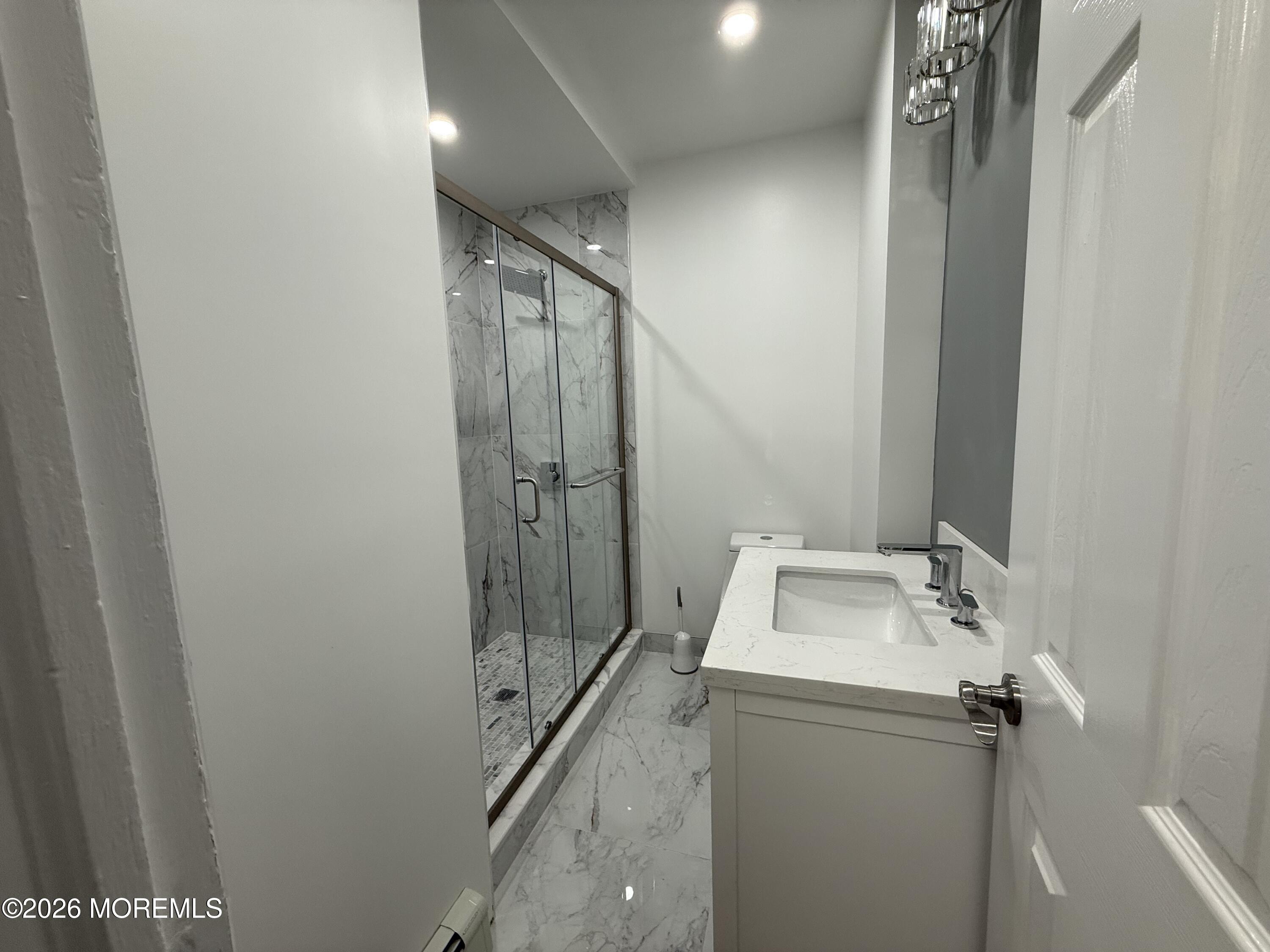 464 2nd Avenue, Unit 1 Long Branch, NJ 07740 - Photo 18 of 37 a bathroom with a sink and mirror