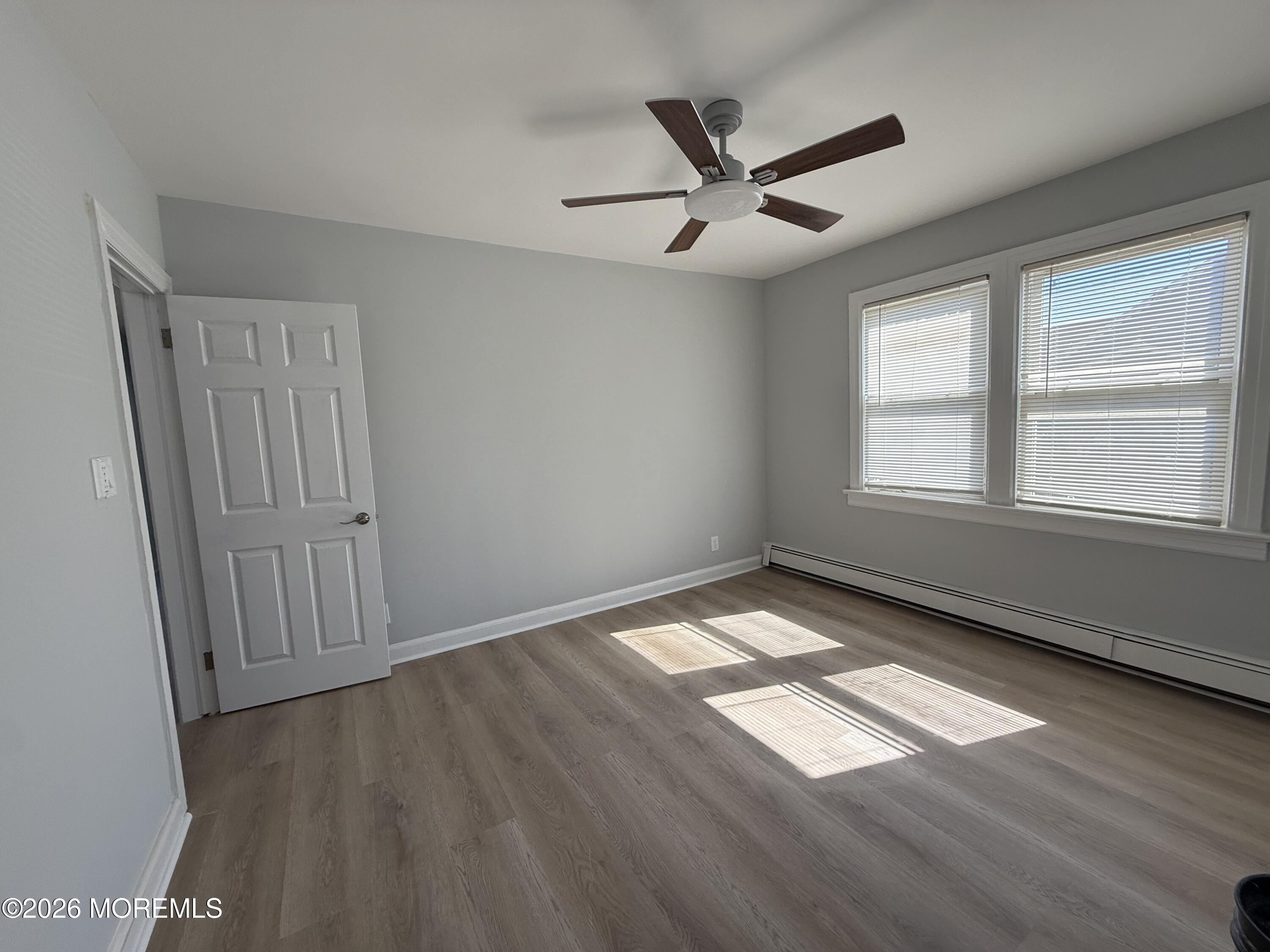 464 2nd Avenue, Unit 1 Long Branch, NJ 07740 - Photo 19 of 37 wooden floor in an empty room with a window