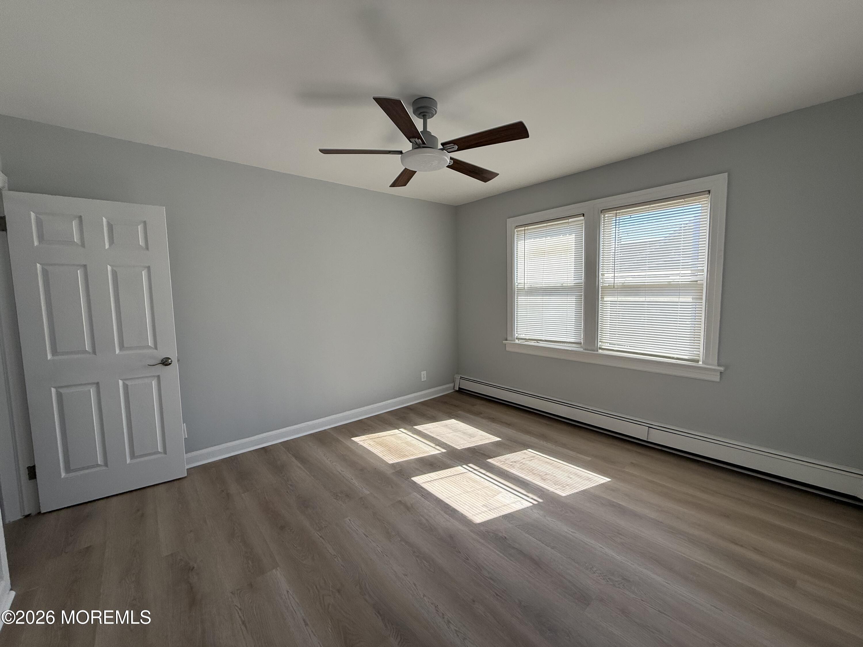 464 2nd Avenue, Unit 1 Long Branch, NJ 07740 - Photo 20 of 37 wooden floor in an empty room with a window