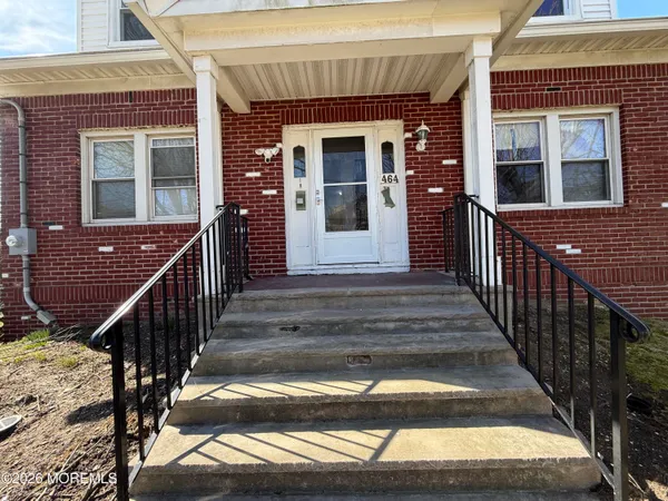 a view of a house with wooden door and windows
