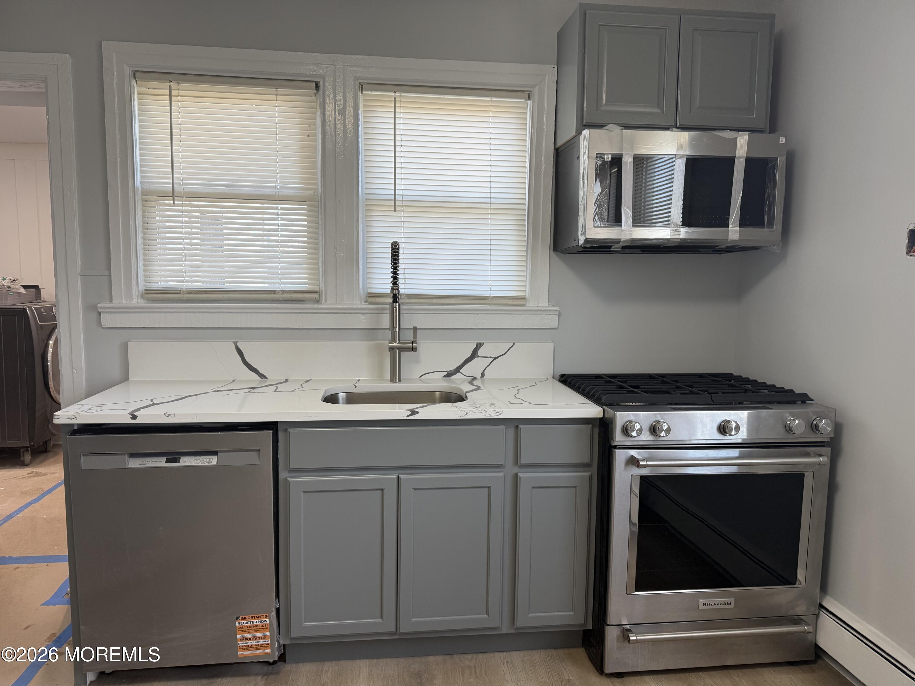 464 2nd Avenue, Unit 1 Long Branch, NJ 07740 - Photo 22 of 37 a utility room with a sink a stove and cabinets
