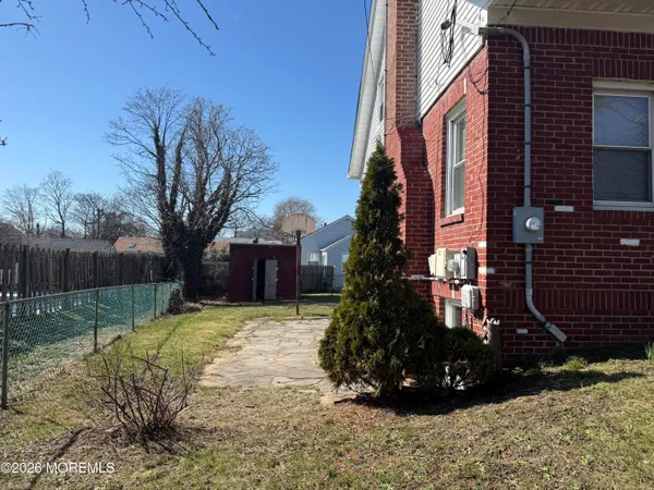 a view of a yard with a house and tree s