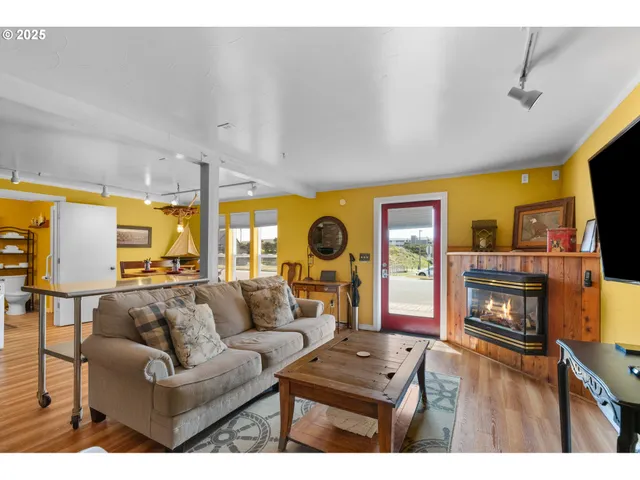 a living room with fireplace furniture and a flat screen tv