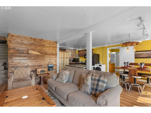 a living room with furniture city view and large windows