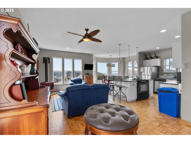 a living room with furniture a flat screen tv and kitchen view