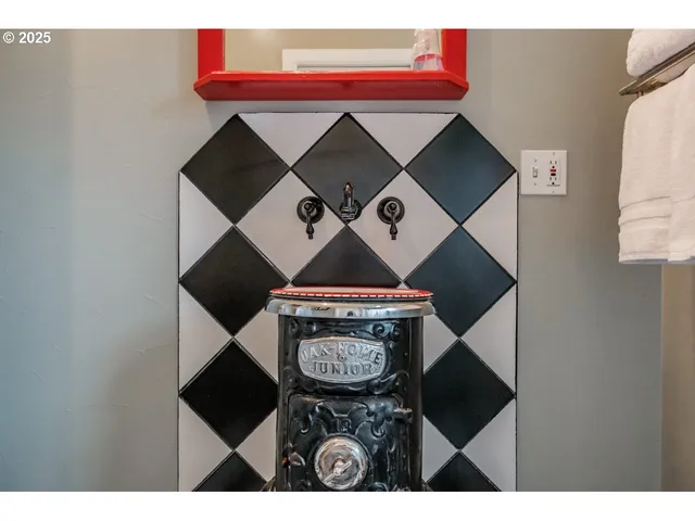 a bedroom with a bed window and a mirror