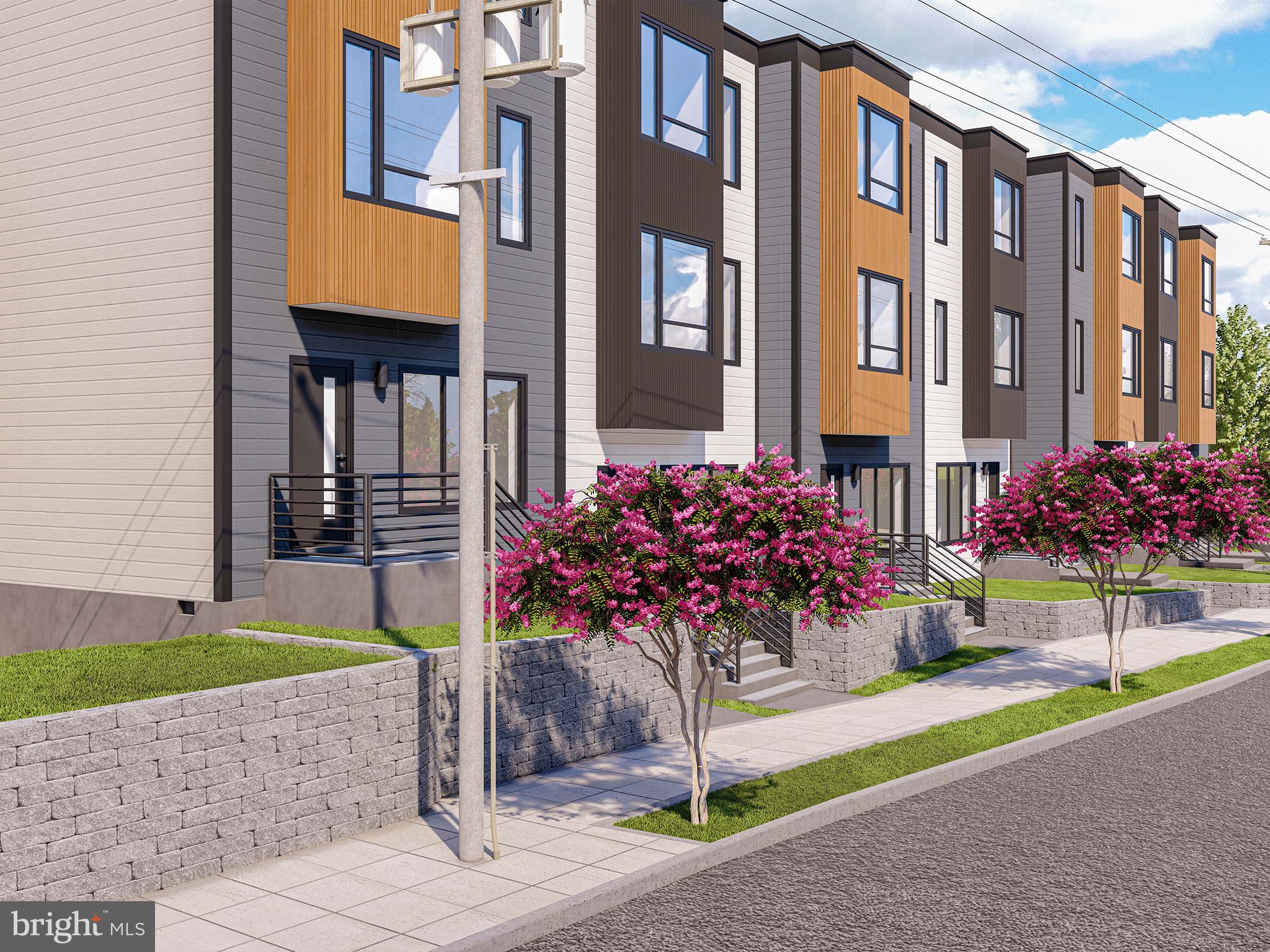 2530 Elvans Road Southeast Washington, DC 20020 - Photo 3 of 5 a front view of a multi story residential apartment building with a yard