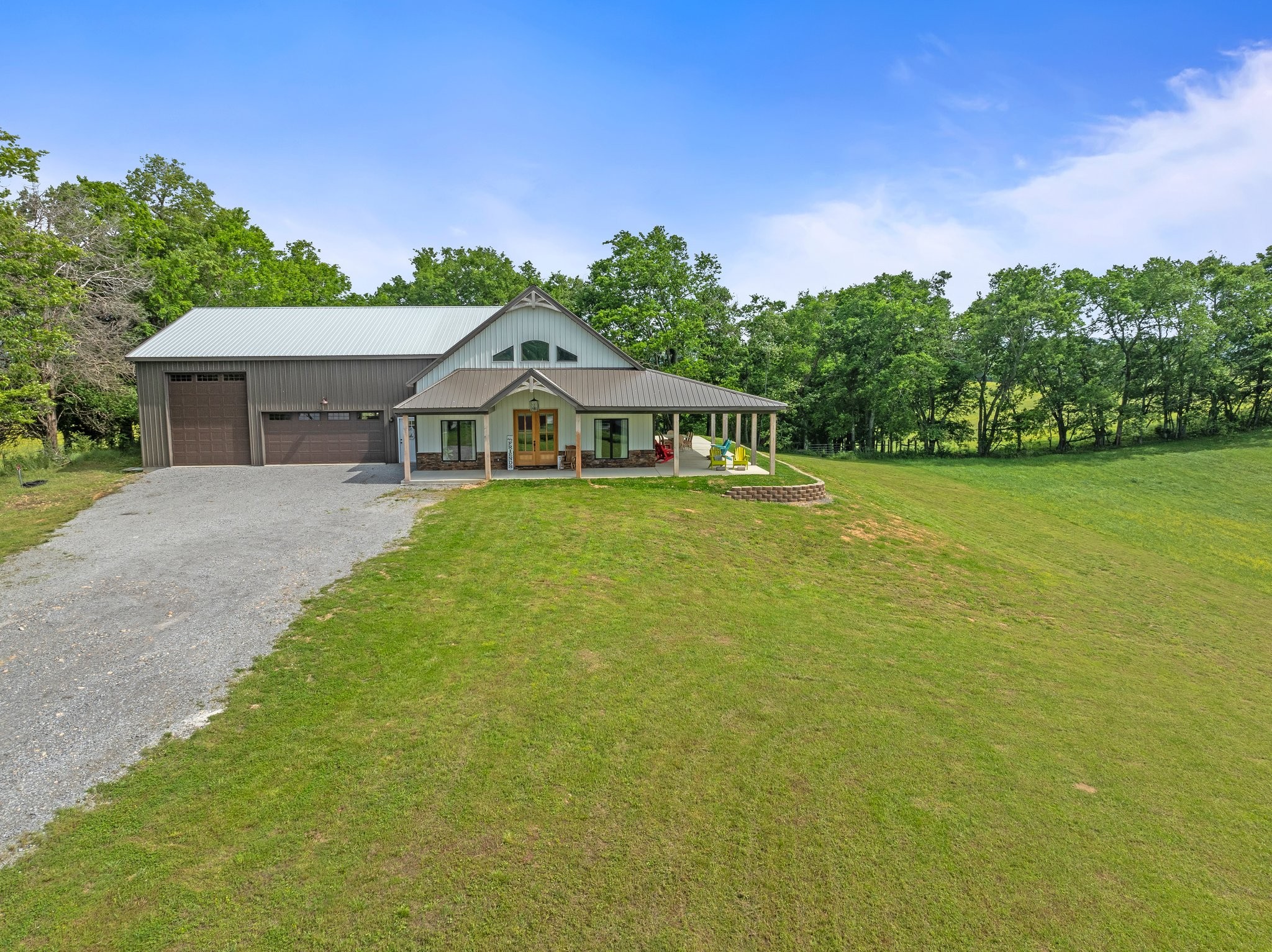 757 Thompson Creek Road Wartrace, TN 37183 - Photo 5 of 42 a view of a patio with table and chairs under an umbrella with large trees