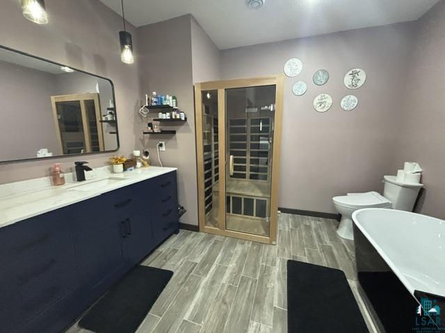 3454 Anderson Road Hibbing, MN 55746 - Photo 8 of 31 Bathroom featuring a built-in sauna, a freestanding soaking tub, and a vanity with a white countertop