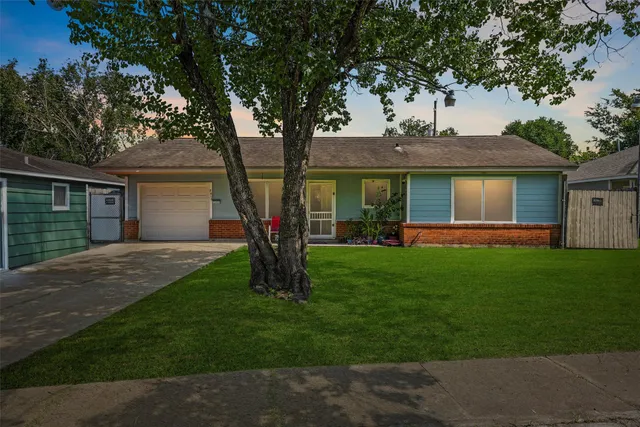 a front view of house with a garden and patio