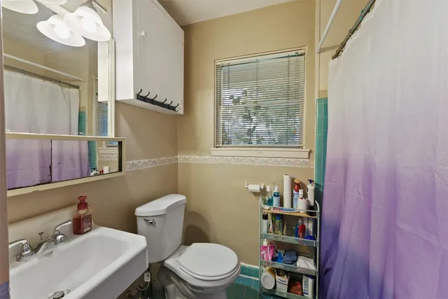 a bedroom with a bed a bookshelf and a closet