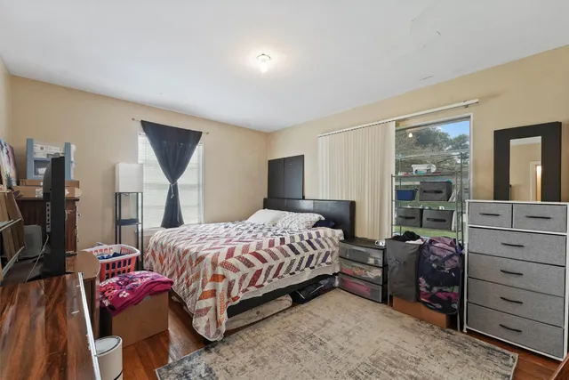 a bedroom with a bed and a flat screen television
