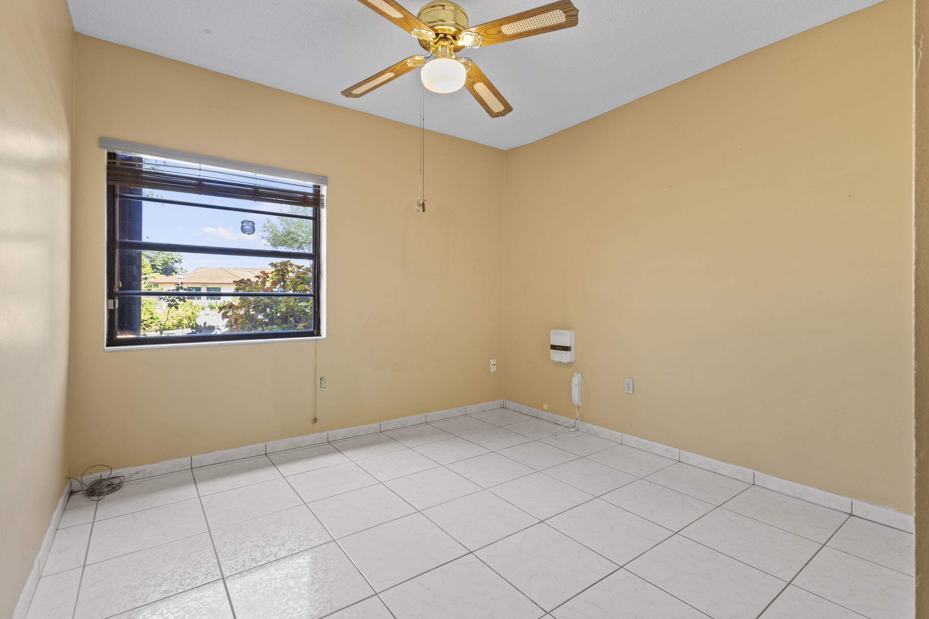 13528 Southwest 9th Lane Miami, FL 33184 - Photo 11 of 24 an empty room with a ceiling fan and window