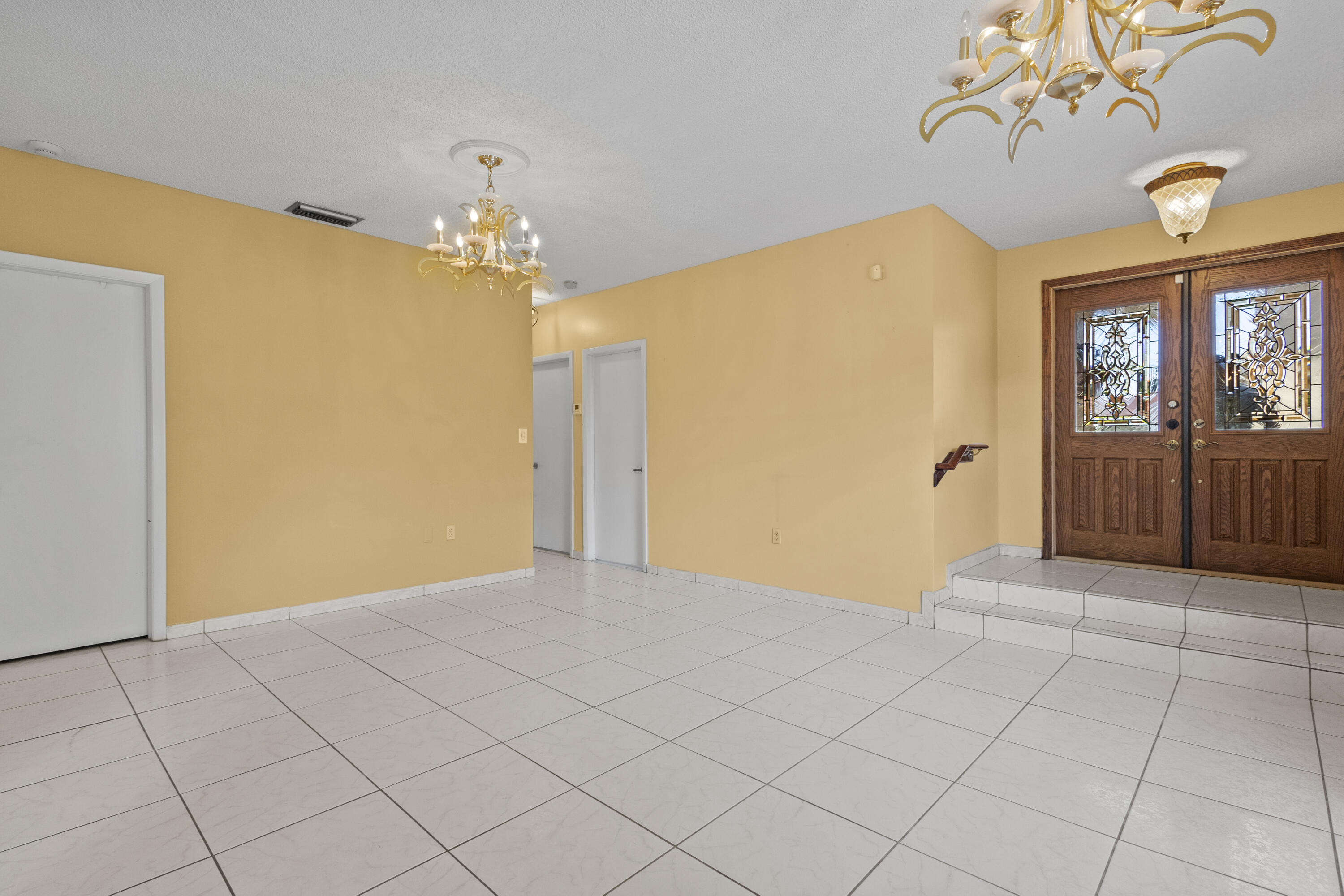 13528 Southwest 9th Lane Miami, FL 33184 - Photo 17 of 24 a view of a hallway with a chandelier