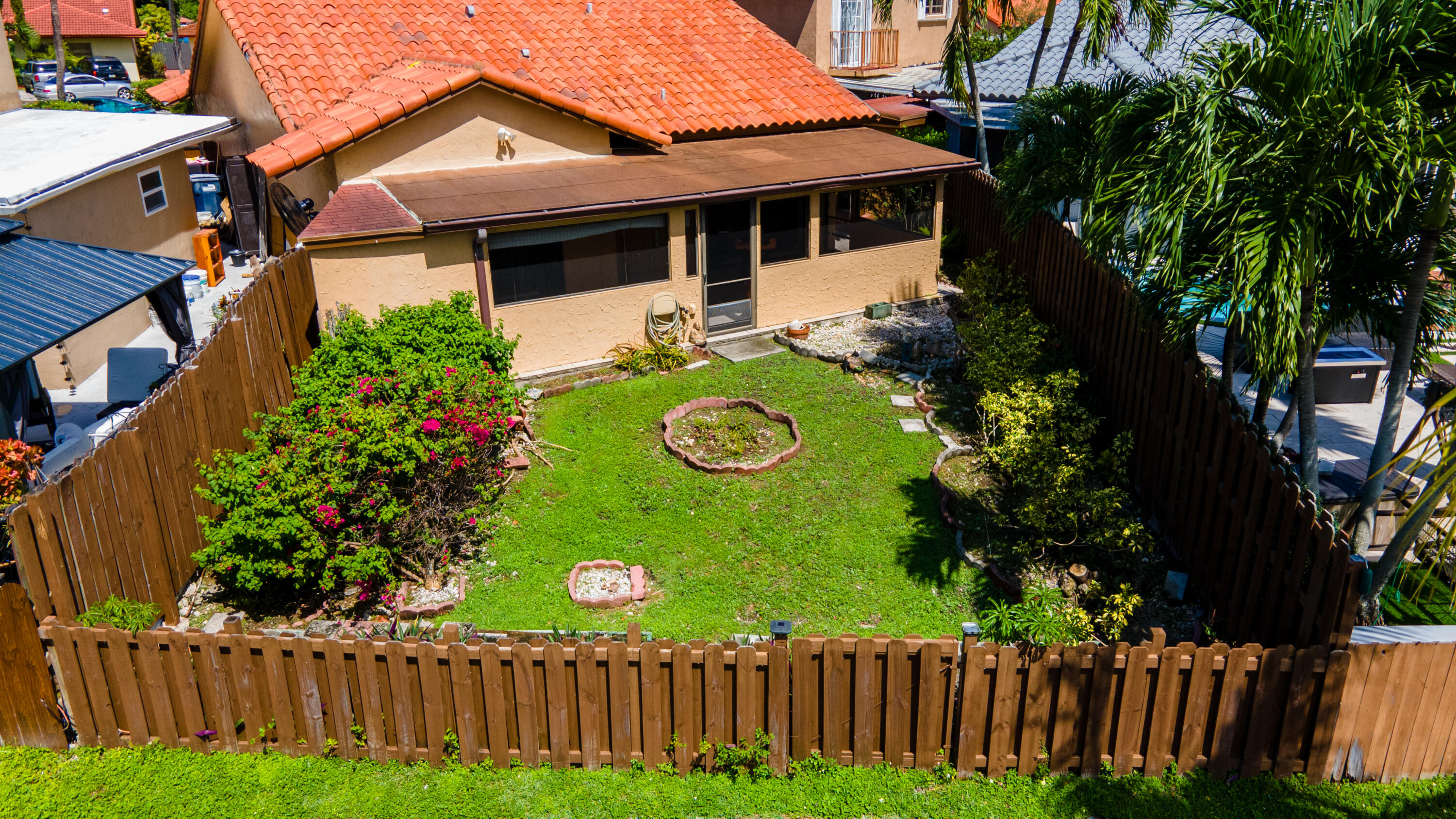 13528 Southwest 9th Lane Miami, FL 33184 - Photo 24 of 24 a view of a house with wooden fence next to a yard