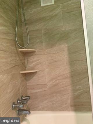 1121 University Boulevard West, Unit 1312 Silver Spring, MD 20902 - Photo 14 of 17 Sleek shower with modern finishes.