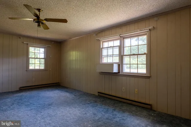a view of room with a ceiling fan and window