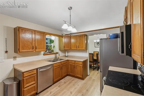 a kitchen with a sink appliances and cabinets