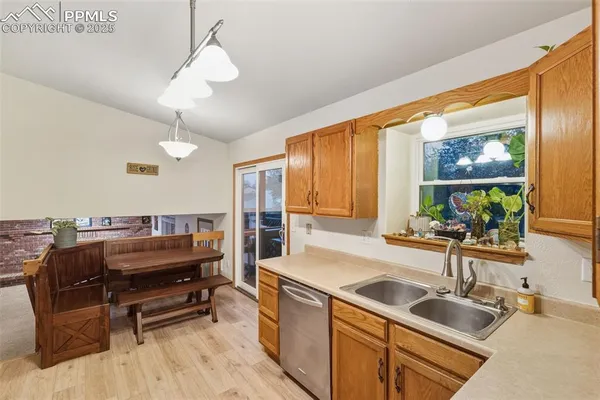 a kitchen with a sink appliances and a counter top space