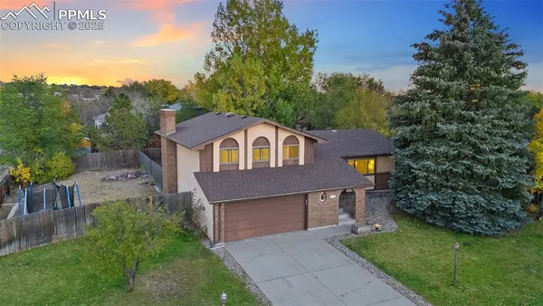 a aerial view of a house next to a yard