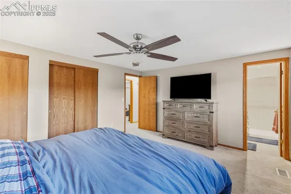 a bedroom with furniture and flat screen tv