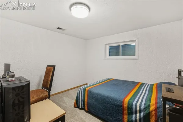 a bedroom with a bed and chair