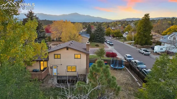 an aerial view of a house with a yard