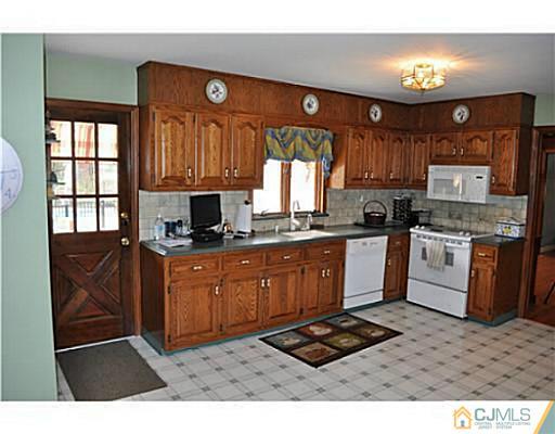 152 Mountainview Road Warren, NJ 07059 - Photo 7 of 10 a kitchen with granite countertop a stove cabinets and a sink