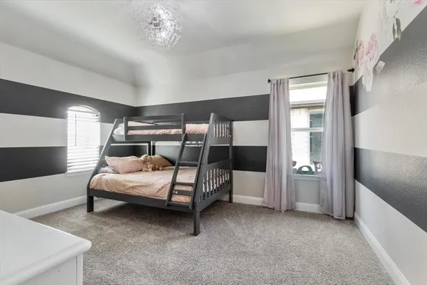 a bedroom with bed and window