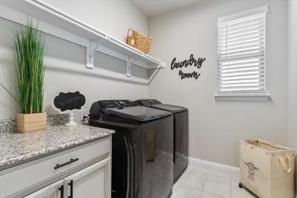 a bathroom with a granite countertop sink a potted plant and a window