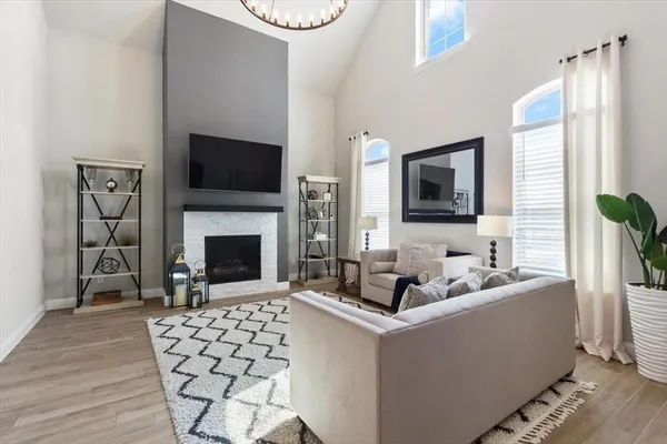 a living room with furniture a fireplace and a flat screen tv