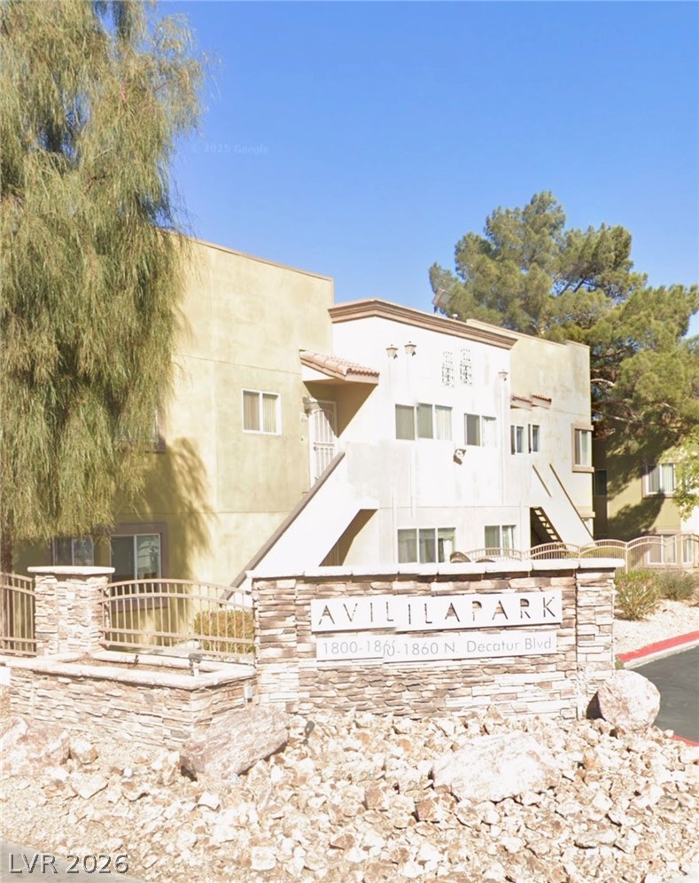 1852 North Decatur Boulevard, Unit 103 Las Vegas, NV 89108 - Photo 1 of 10 A welcoming stone-clad sign marks the entrance to this multi-unit community.