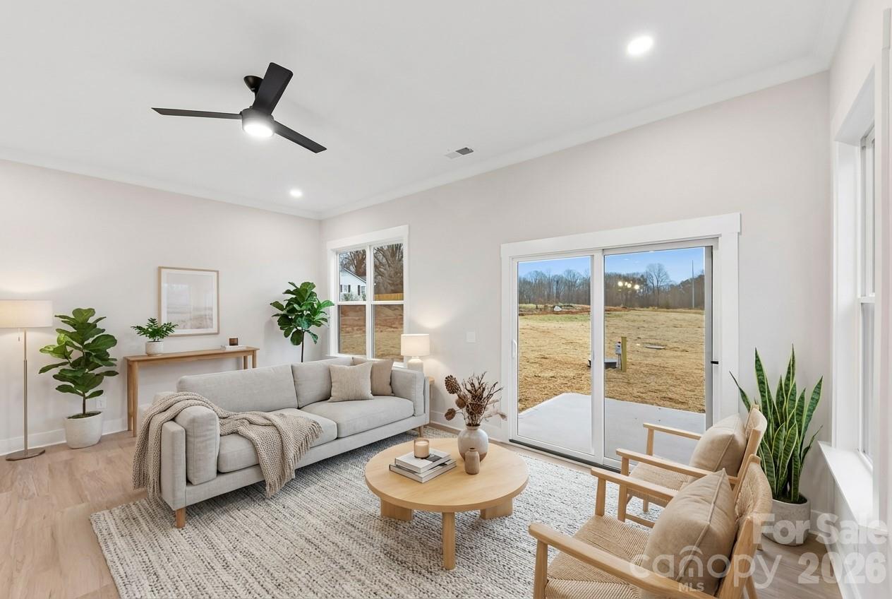 551 Perry Road Troutman, NC 28166 - Photo 13 of 47 a living room with furniture and a large window