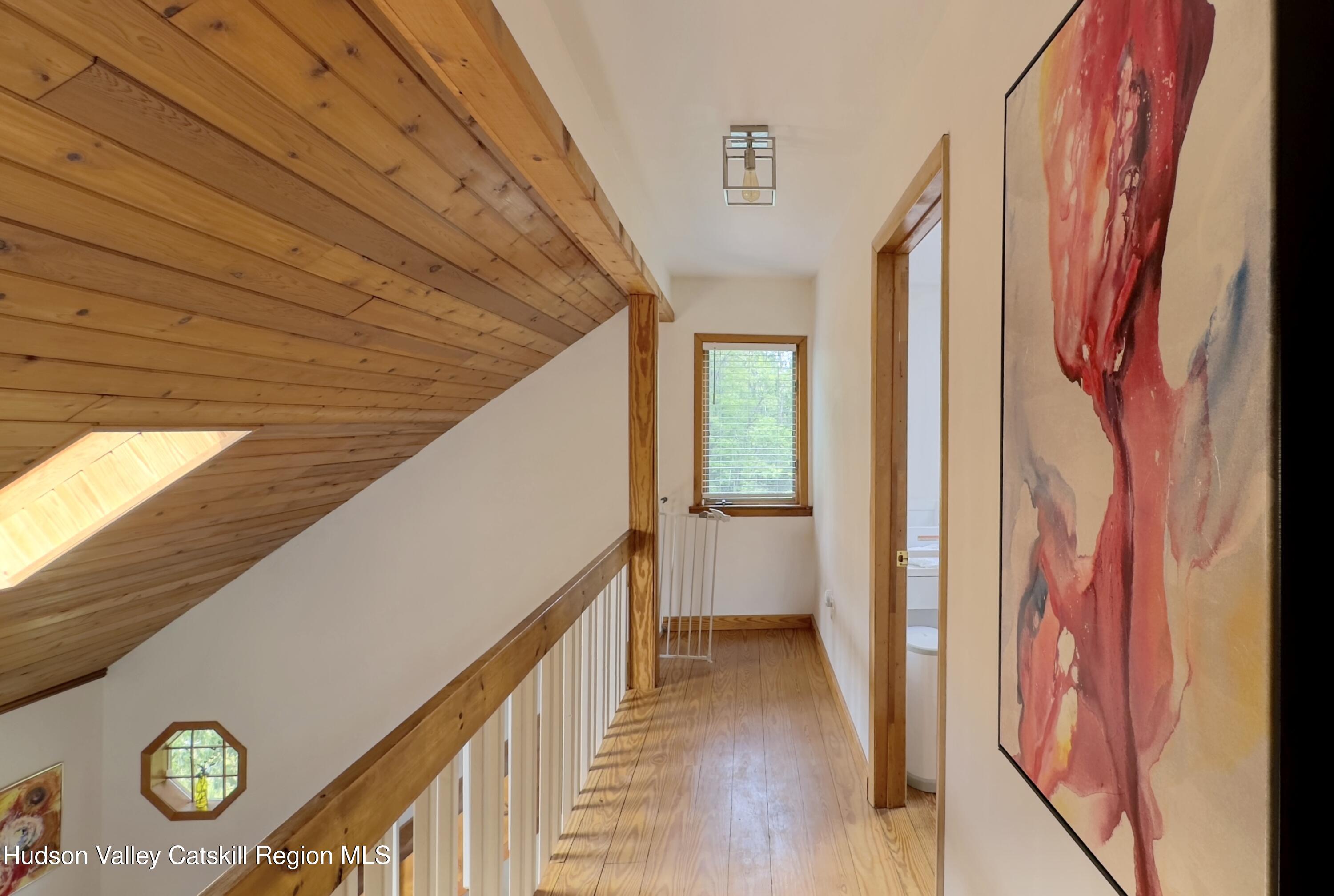 1542 Sleepy Hollow Road Athens, NY 12015 - Photo 12 of 27 a view of a hallway with wooden floor and staircase