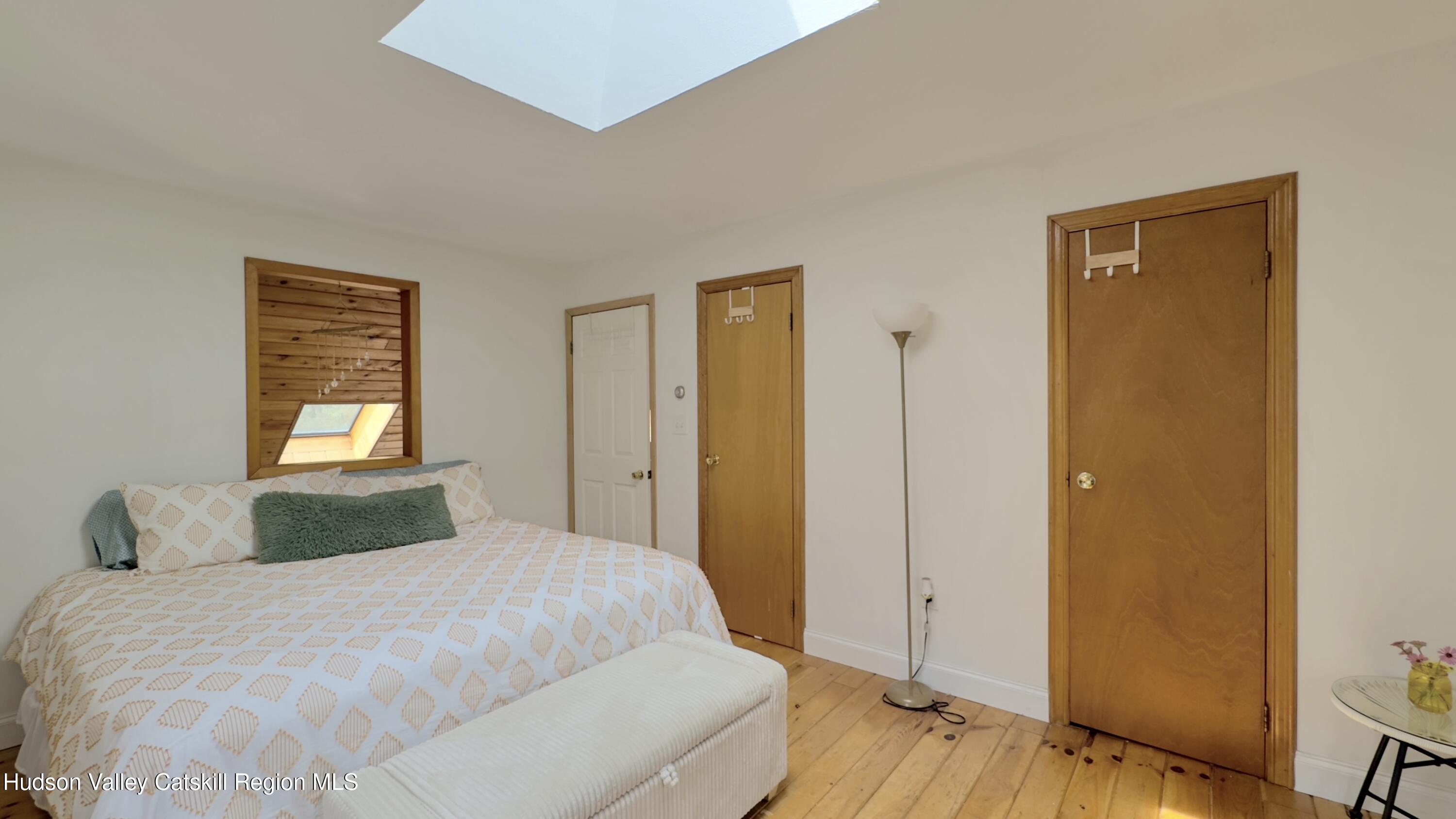 1542 Sleepy Hollow Road Athens, NY 12015 - Photo 16 of 27 a bedroom with a bed and a window