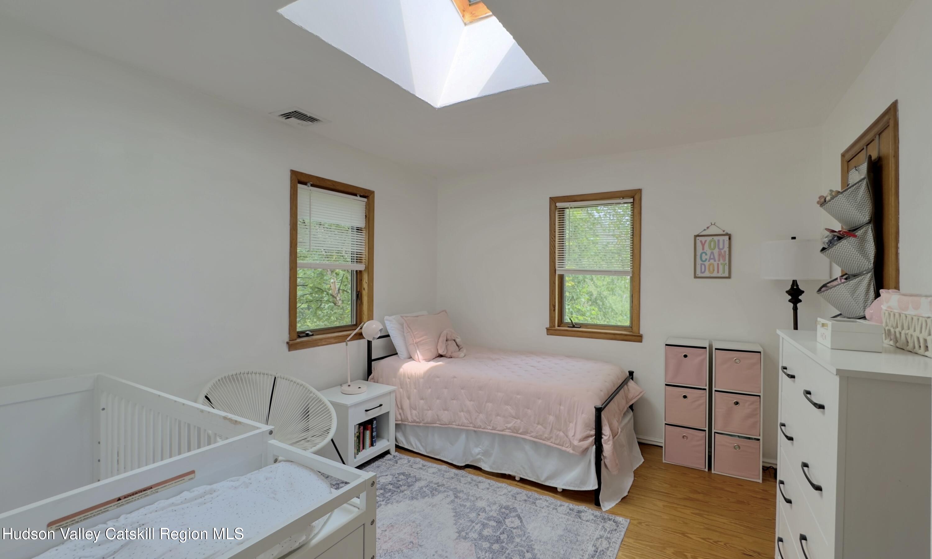 1542 Sleepy Hollow Road Athens, NY 12015 - Photo 17 of 27 a bedroom with a bed and a window