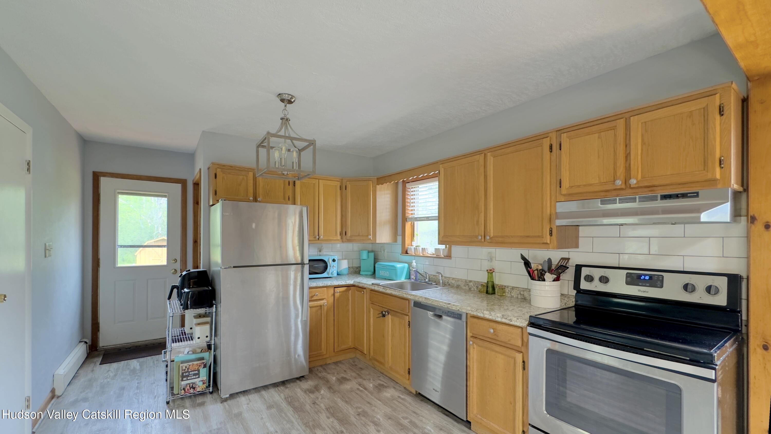 1542 Sleepy Hollow Road Athens, NY 12015 - Photo 3 of 27 a kitchen with a refrigerator a stove cabinets and a wooden floor