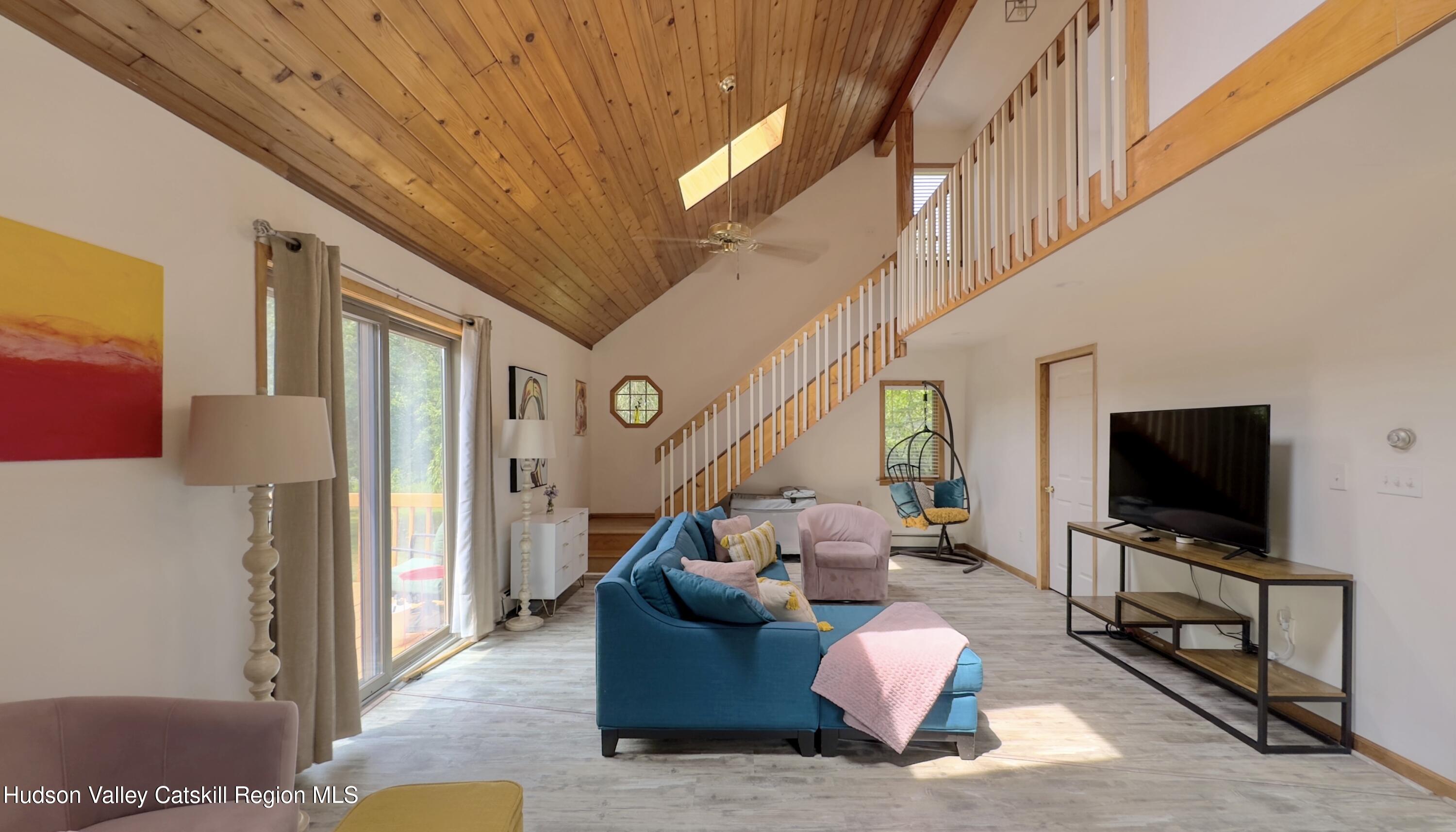 1542 Sleepy Hollow Road Athens, NY 12015 - Photo 6 of 27 a living room with furniture a flat screen tv and a wall painting