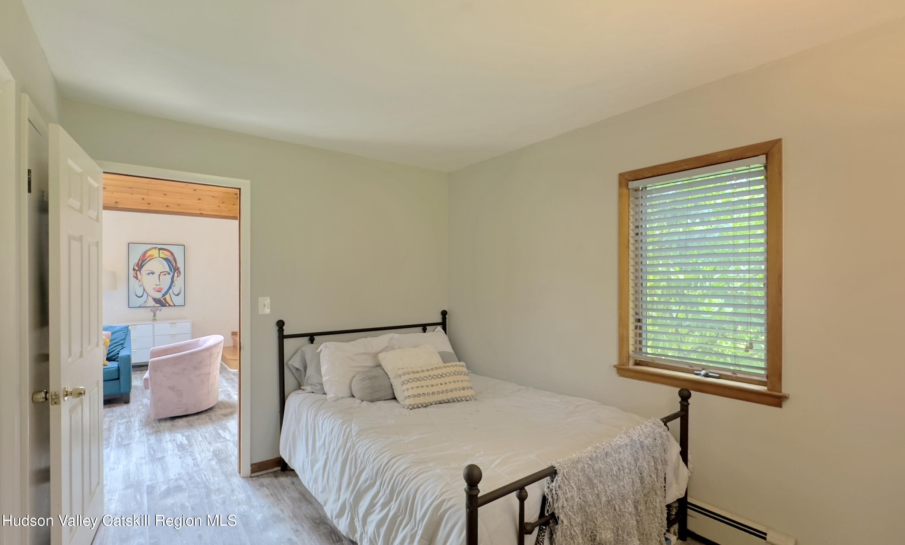 1542 Sleepy Hollow Road Athens, NY 12015 - Photo 9 of 27 a bedroom with a bed and a window