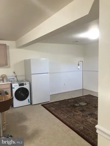 a kitchen with a stove a refrigerator and a sink