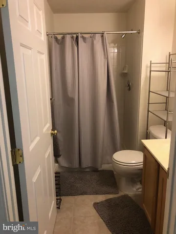 a bathroom with a granite countertop shower and a sink