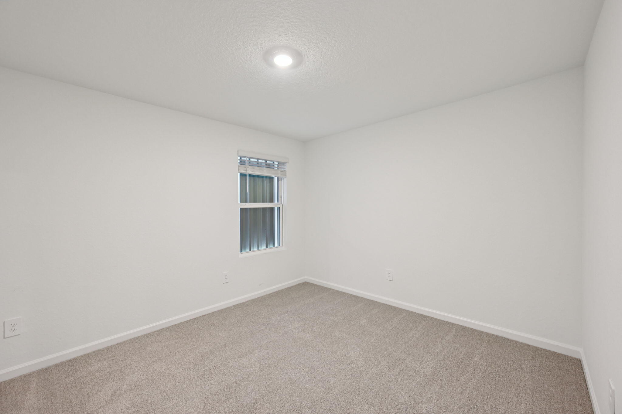 14202 Southwest New Dawn Road Indiantown, FL 34956 - Photo 15 of 27 an empty room with a window