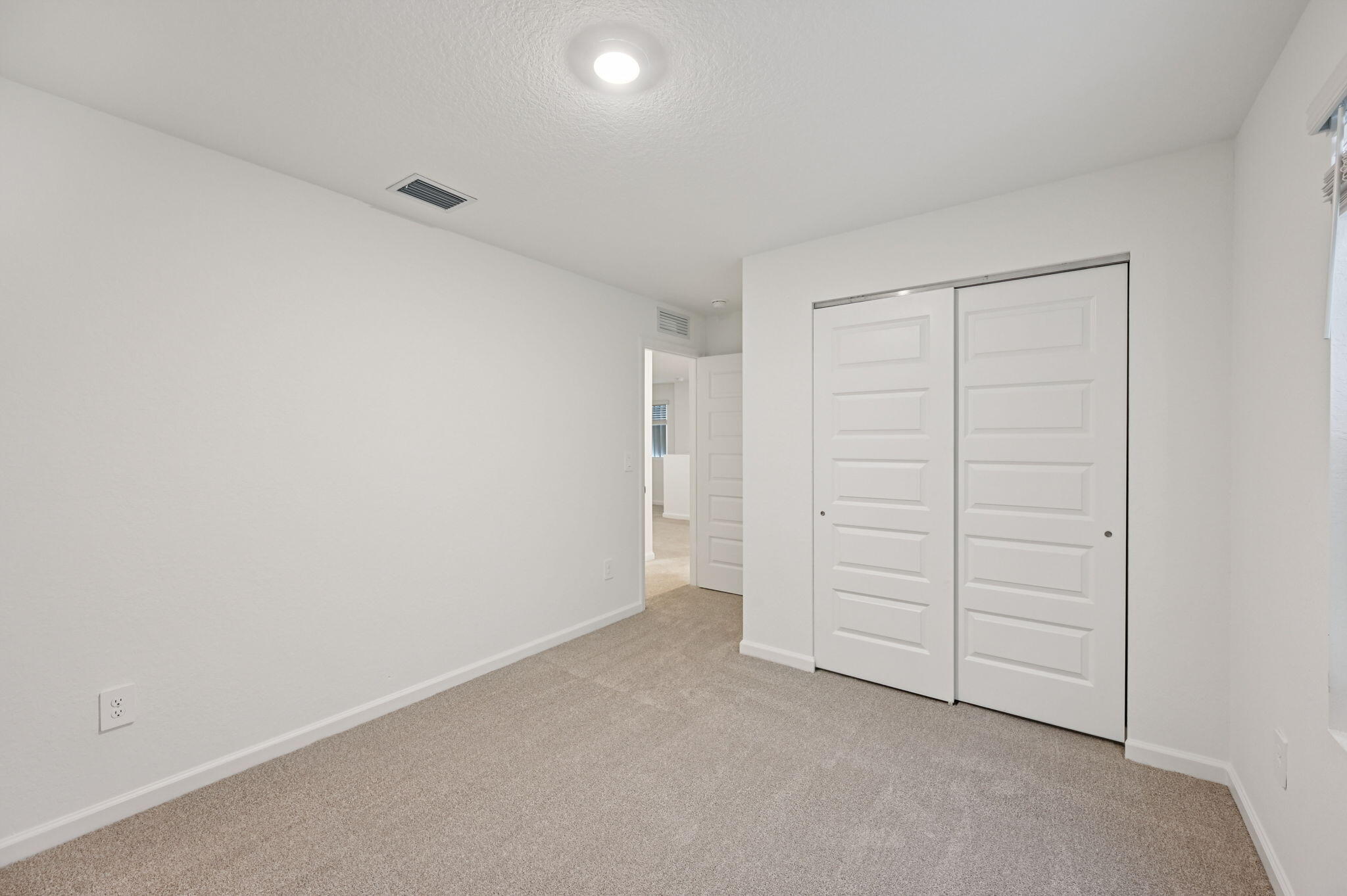 14202 Southwest New Dawn Road Indiantown, FL 34956 - Photo 22 of 27 an empty room with closet area
