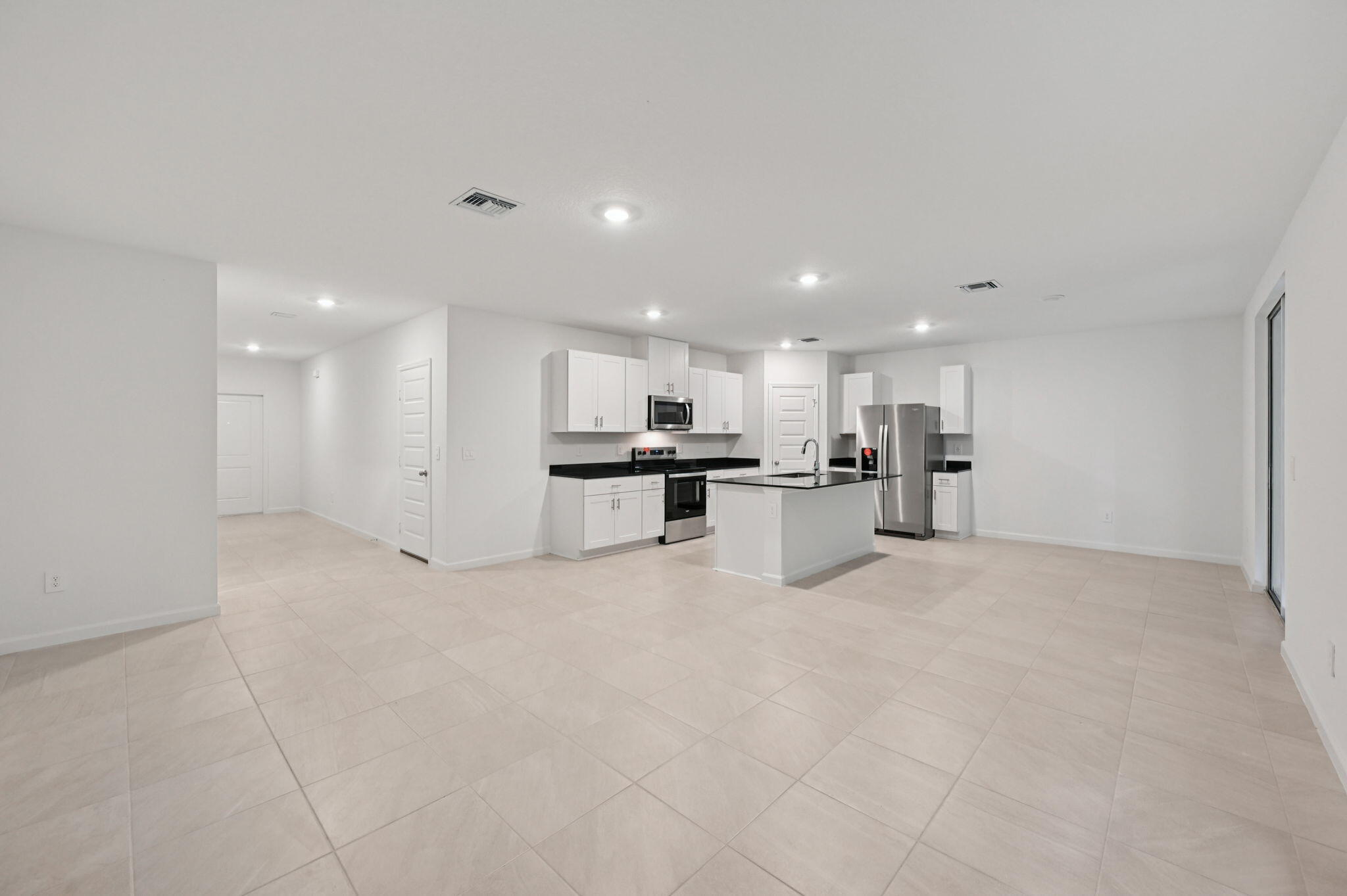 14202 Southwest New Dawn Road Indiantown, FL 34956 - Photo 8 of 27 a view of kitchen with kitchen island white cabinets appliances and center island