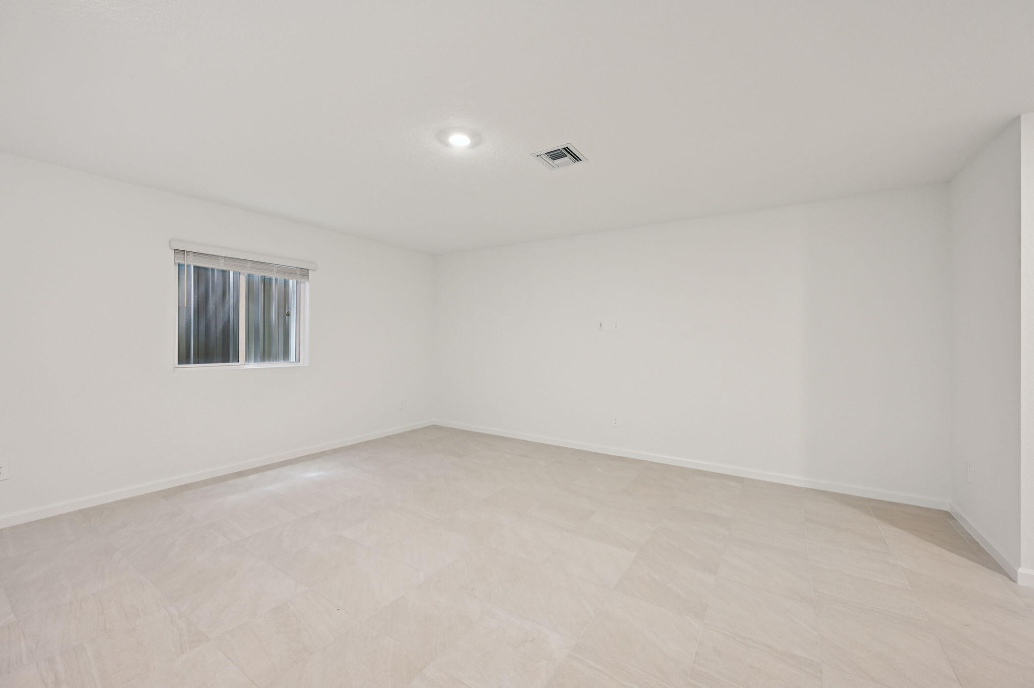 14202 Southwest New Dawn Road Indiantown, FL 34956 - Photo 9 of 27 an empty room with a empty space and windows