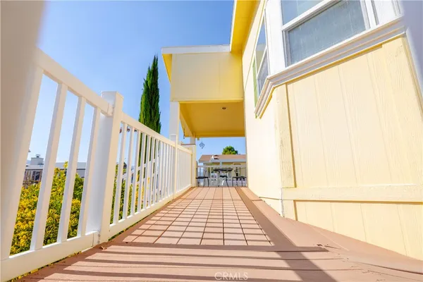 a view of balcony with wooden floor and furniture
